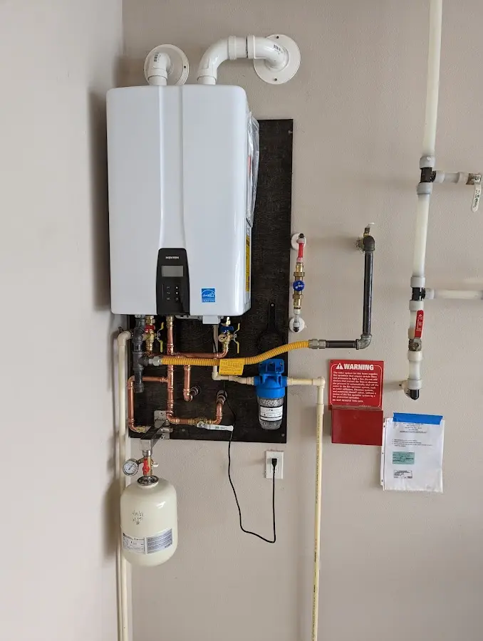 Professional plumber installing copper piping in a Grosse Ile home